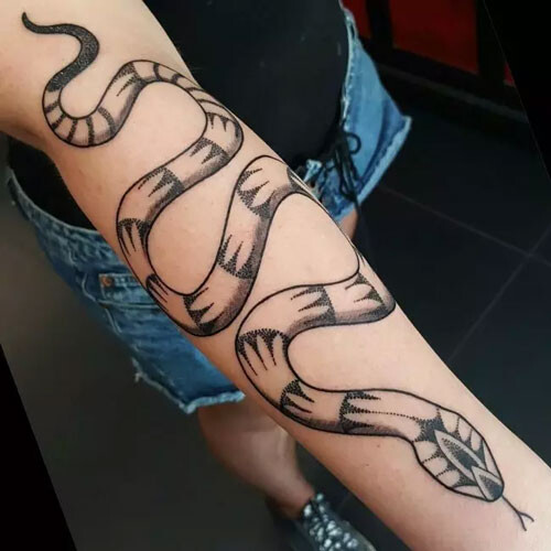 snake wrapped around arm tattoo
