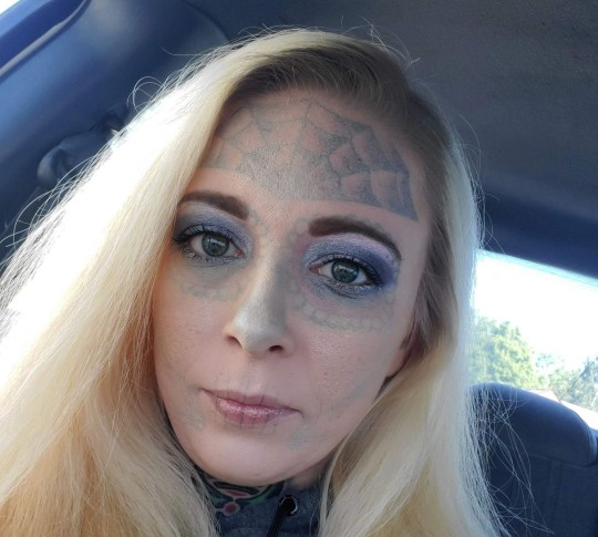 PIC FROM Kennedy News and Media (PICTURED: ALYSSA ZEBRASKY, 31, WITH MAKEUP COVERING HER FACE TATTOOS) A woman whose mugshot went viral for her heavily tattooed FACE is undergoing gruelling laser treatment to blast the inking off - in a bid to forget the ex who she was arrested with. Alyssa Zebrasky, Cleveland, Ohio, US, underwent the elaborate Day of the Dead tatt four years ago, while in a toxic relationship with an ex-partner who also had elaborate face inkings. The 31-year-old got a spider web on her forehead as well as black shading around her eyes, nose, cheeks and lips in two arduous sessions in June 2018. DISCLAIMER: While Kennedy News and Media uses its best endeavours to establish the copyright and authenticity of all pictures supplied, it accepts no liability for any damage, loss or legal action caused by the use of images supplied and the publication of images is solely at your discretion. SEE KENNEDY NEWS COPY - 0161 697 4266